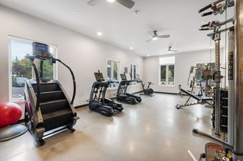A spacious gym with a variety of exercise equipment.